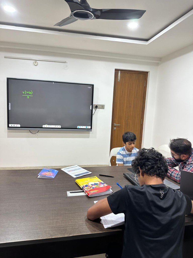 Class 8 Maths in session: founder teaching a small batch at Ankuram, Jubilee Hills — algebra on the digital whiteboard.